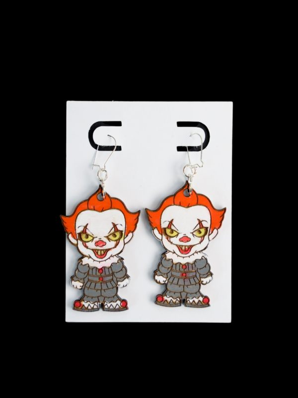 Pennywise wood earrings with a gray suit and orange hair earrings.