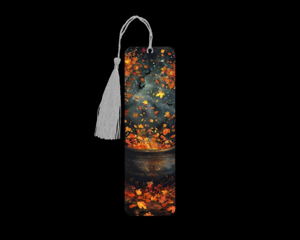 Autumn cauldron metal bookmark. The bookmark is metal with a silver tassel. The image is printed onto the top and is smooth and glossy.