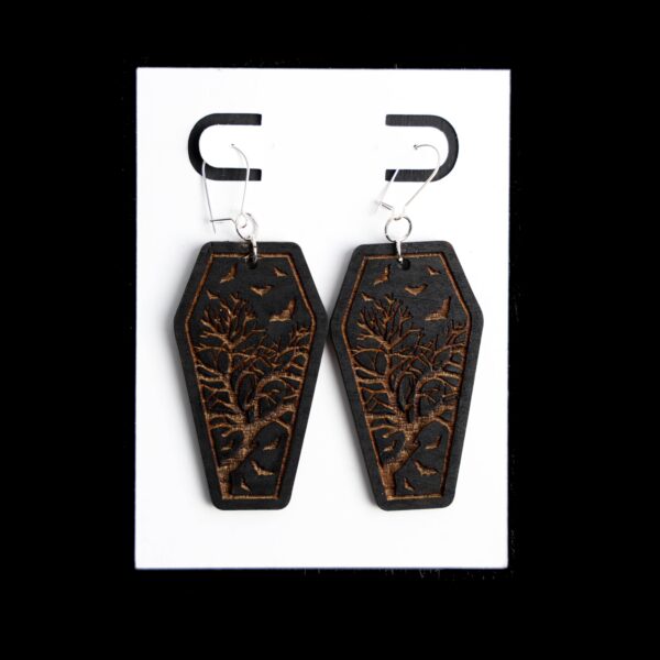 Coffin Black Earrings. These earrings are made with 1/8″ thickness basswood. These earrings are lightweight and hand painted. They are not sealed to keep a rustic look and feel. Features: 2″ Earring in Length Made with 1/8″ Basswood; Lightweight Nickel Free Kidney Earring Wires Nickel Free Jump Rings Colors may vary due to screen resolution. All earrings are unique as these are hand painted. Not sealed for easy touch up. They may different slightly from the listing image.