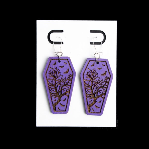 Coffin Purple Earrings. These earrings are made with 1/8″ thickness basswood. These earrings are lightweight and hand painted.