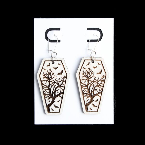 Coffin White Earrings. These earrings are made with 1/8″ thickness basswood. These earrings are lightweight and hand painted.